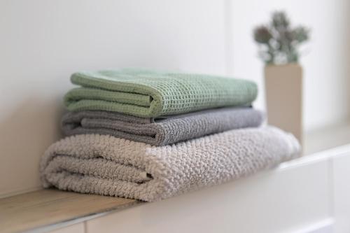 a stack of towels on a shelf in a bathroom at Gästehaus Hegerweg 2, Calden in Calden