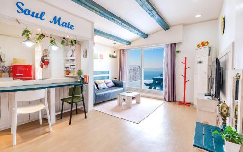 a kitchen and living room with a view of the ocean at Soulmate Pension in Namhae