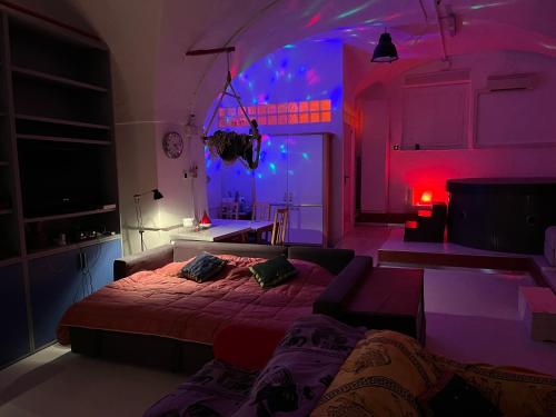 a bedroom with a bed and a purple lighting at Ilsoleresort in Genoa