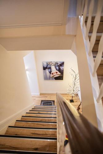 a staircase in a room with a painting on the wall at Altstadtjuwel @Conny's in Brilon