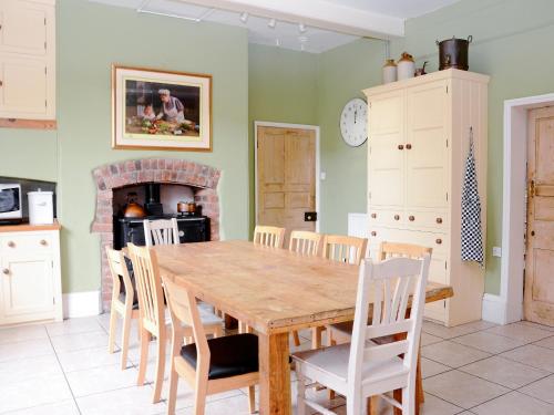 a dining room with a wooden table and chairs at Abbotts Farm in Horbling