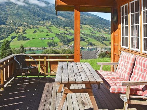 a wooden porch with a wooden table and a bench at 5 person holiday home in olden in Olden