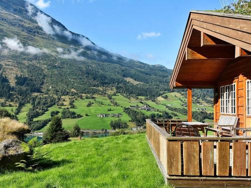 a house with a balcony with a view of a mountain at 5 person holiday home in olden in Olden