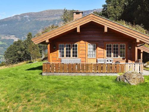 a wooden cabin on a hill with a green field at 5 person holiday home in olden in Olden