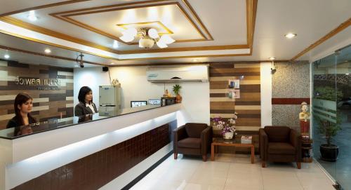 a woman standing at the counter of a salon at View Place Hotel & Residence in Bangkok
