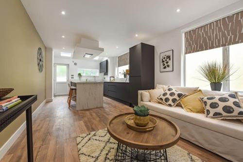 a living room with a couch and a table at Modern Two Bed with En-Suites and Private Parking in Cardiff