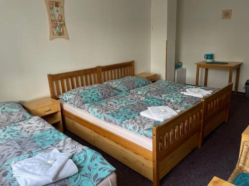 two twin beds in a room with at Pension Hájek in Prague