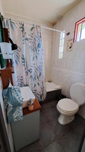 a bathroom with a toilet and a sink and a tub at Boutique Hotel Casa Rugantino in Buenos Aires