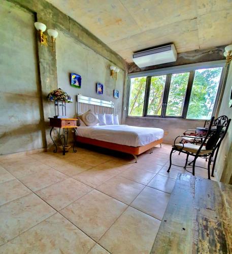 a bedroom with a bed and a table and chairs at Dos Aguas in Rio Grande