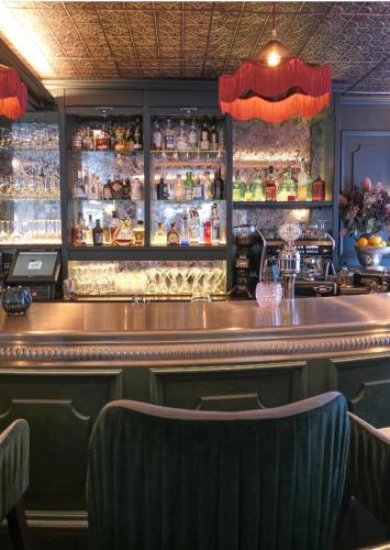 a bar with two chairs in front of a counter at Chalet Antoine serviced Apartments by Mirabeau in Zermatt