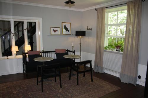 a dining room with a table and chairs and a window at Borregården Bed & Breakfast in Borrby