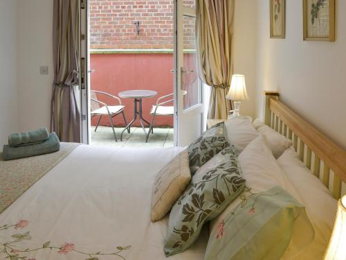 a bedroom with a bed and a patio with a table at Number 7 in Whitby