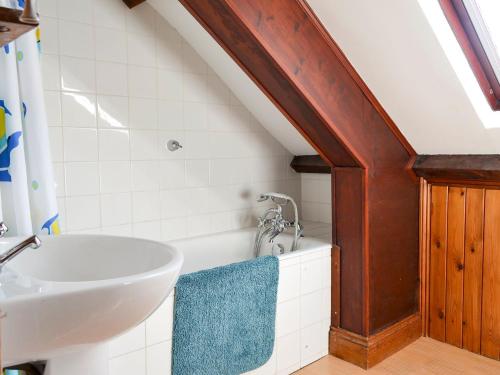 a bathroom with a sink and a bath tub at Felbridge Cottage in Bardon Mill