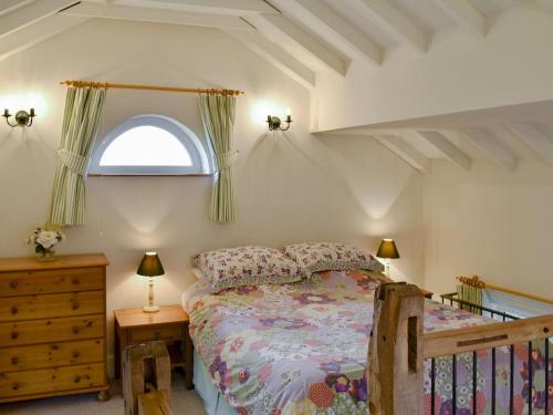 a bedroom with a bed and a window at Orchard Chapel in Much Marcle