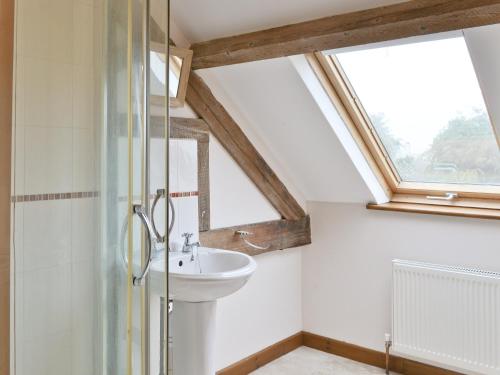 a bathroom with a sink and a window at Coriander - E4323 in Ludham