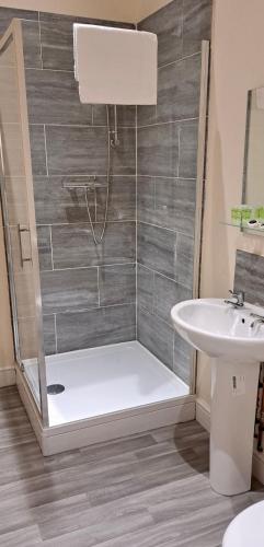 a bathroom with a shower and a sink at The Windmill Hotel in Lincolnshire