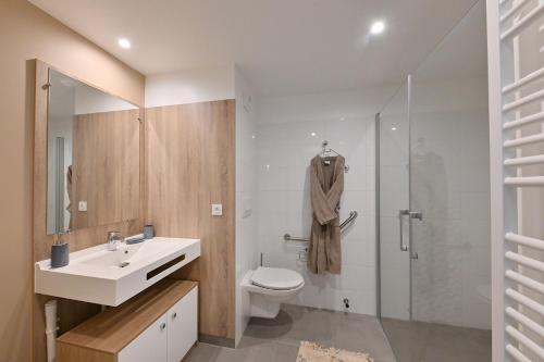 La salle de bains est pourvue de toilettes, d'un lavabo et d'une douche. dans l'établissement Résidence Services CAZAM, à Clermont-Ferrand