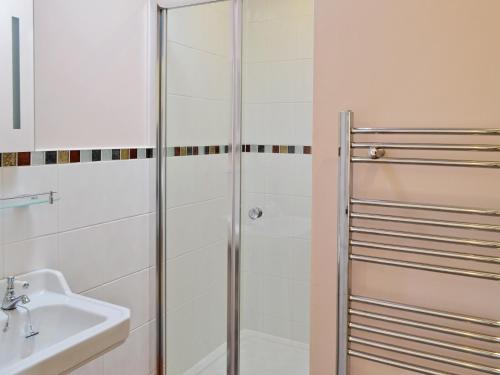 a bathroom with a shower and a sink at Woodlanders - 29954 in Wootton Glanville