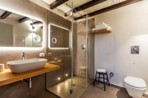 een badkamer met een wastafel en een glazen douche bij Isula in Palermo