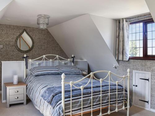 a bedroom with a bed with a white bed frame at Leighwood in Sandwich