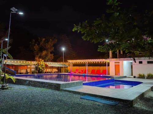 ein Schwimmbad in der Nacht mit Lichtern in der Unterkunft EA Apartelle - Metro Vigan in Vigan City