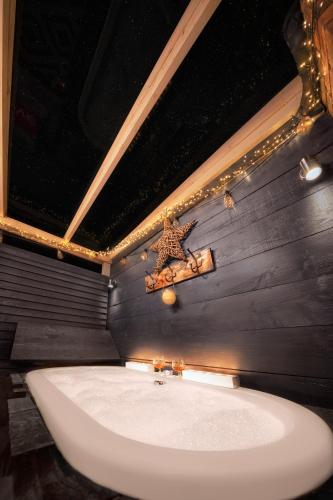 a bathroom with a sink and a cross on the wall at The Nest Barnlette in Wrenbury