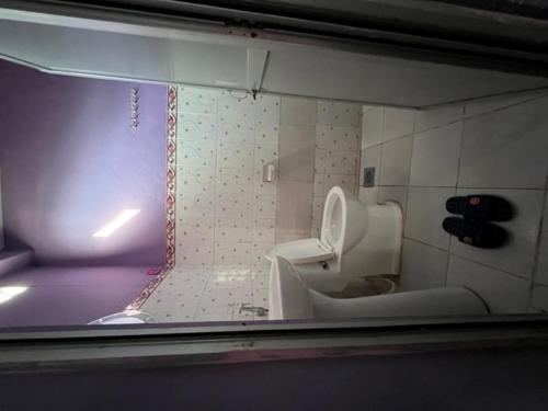 a bathroom with a toilet and a bath tub at Three Angels Lodge & Restaurant in Chitwan