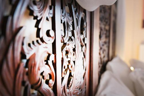 a close up of a wooden headboard of a bed at A Dream Deferred villa Pelion in Kissós