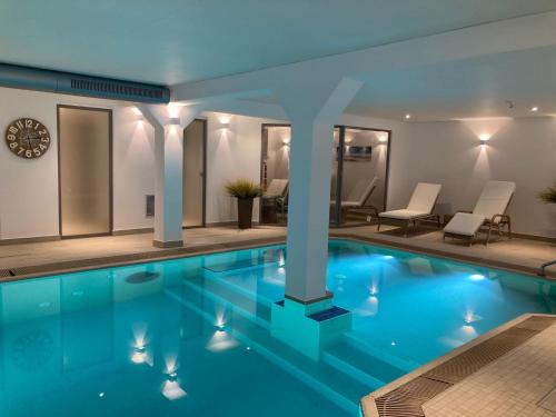 a swimming pool with lights in a building at Inselresidenz Strandburg Apartment 209 in Juist