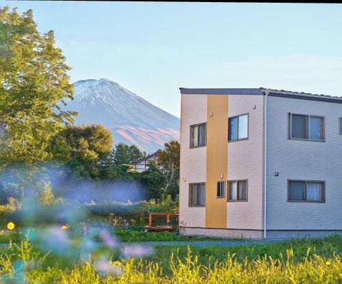 a building with a mountain in the background at ヴィラ山間堂Panorama Villa BBQ Bonfire Fuji view Annovillas Sankando in Fujikawaguchiko