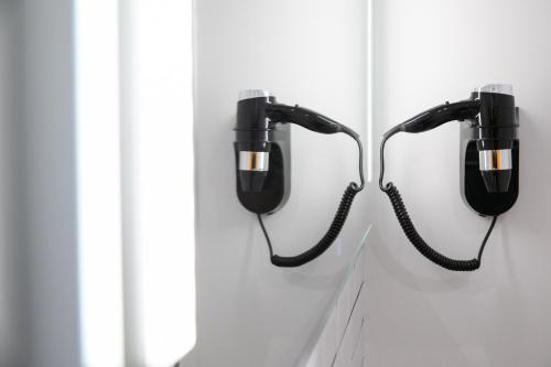 a pair of phones hanging on a wall at Le Maleville - Appartements de Standing in Périgueux