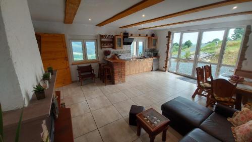 a living room with a couch and a kitchen at Orle Gniazdo in Kamienna Góra