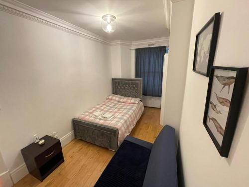 a small bedroom with a bed and a table at Cozy Double Room in Marylebone-Paddington #room name is amsterdam# in London