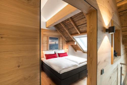 a small bedroom in a tiny house with a window at Ferienwohnung im Chaletstil Bergloft 115 qm Wellness Fitness Sauna Bergrödelhof in Feilitzsch