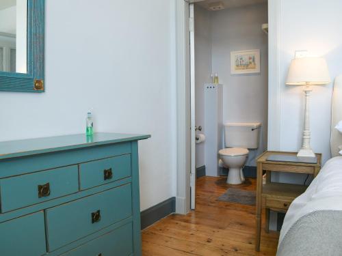a bedroom with a blue dresser and a toilet at St Andrews in Pittenweem