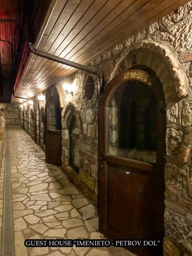 a stone alley with a door in a building at Imenieto in Petrovdol