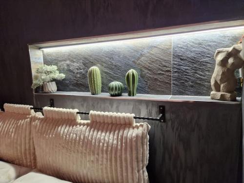 a room with a couch and cactuses on a wall at Biblioteka Spa Suite in Novi Beograd