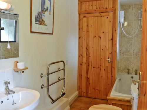 baño con lavabo y puerta de madera en Judd, en Launceston