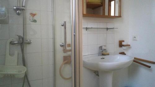a white bathroom with a sink and a shower at Les lauriers in Hyères