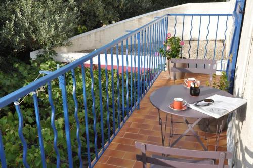 a table and two chairs on a balcony at Le pre adrien in Rocbaron