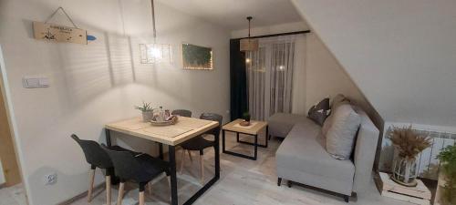 a living room with a table and a couch at Moje Pieniny Apartament in Szczawnica