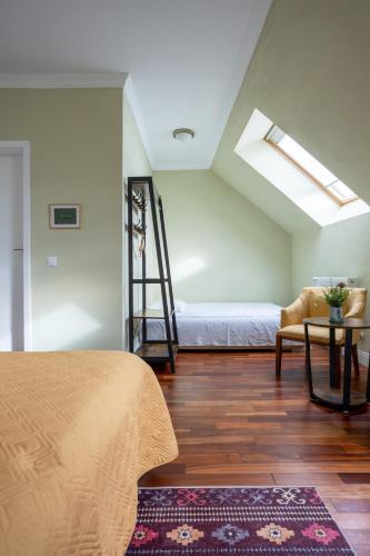 a bedroom with a bed and a ladder and a table at Vila Missy in Deva