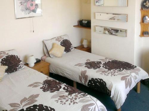 two twin beds in a room with at Tudor Cottage in Ainsdale