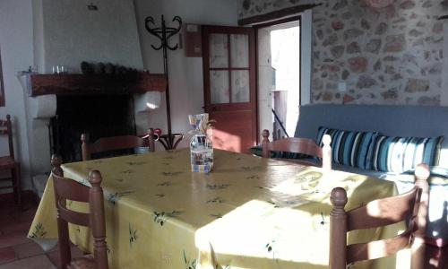 une table de salle à manger avec une nappe jaune avec des araignées dessus dans l'établissement L'horloge, à Moissac-Bellevue