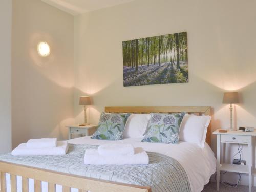 a bedroom with a bed with two pillows on it at Pear Tree Cottage in Wirksworth