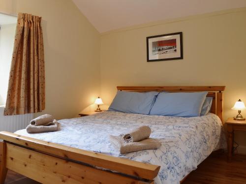 a bedroom with a bed with two towels on it at Helm View in Windermere