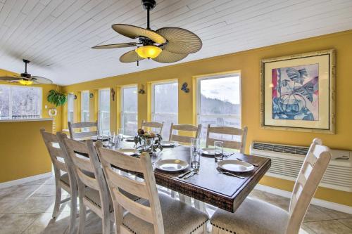 a dining room with a table and a ceiling fan at Lake-View Osage Beach Resort Home with Game Room! in Osage Beach