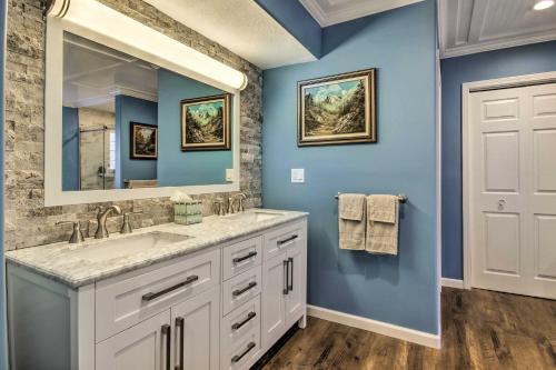 a bathroom with a sink and a mirror at Lake-View Osage Beach Resort Home with Game Room! in Osage Beach