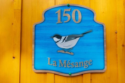 a sign on a wall with a bird on it at Domaine Rivière Sacacomie in Saint-Alexis-des-Monts