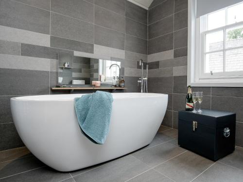 a white bath tub in a bathroom with a window at Knocktinkle in Gatehouse of Fleet